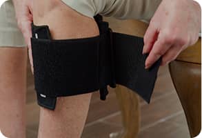 Older person wrapping the BeActive® Plus around their knee